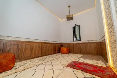 an empty living room with wood paneling and a tv at Villa vue atlas marrakech in Marrakech