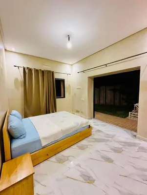a bedroom with a bed and a flat screen tv at Villa Nadia Marrakech in Marrakech