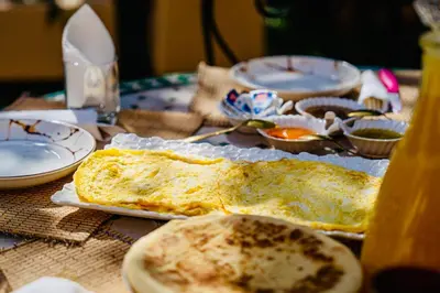 a table topped with an omelet on top of a table at Villa Nadia Marrakech in Marrakech