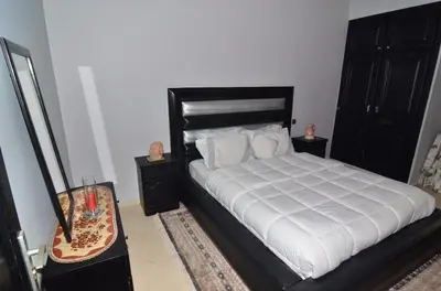 a bedroom with a large bed with white sheets and pillows at Appartement au coeur de Fès in Fès