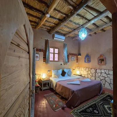 a bedroom with a large bed in a room at Riad Paradise of Silence in Aït Ben Haddou