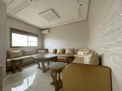 a living room with a couch and a table at Housse Fez City in Fès