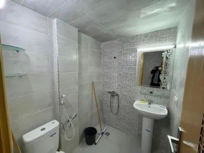 a bathroom with a sink and a toilet and a mirror at Housse Fez City in Fès
