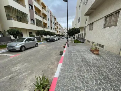 a car parked on the side of a street with buildings at Housse Fez City in Fès