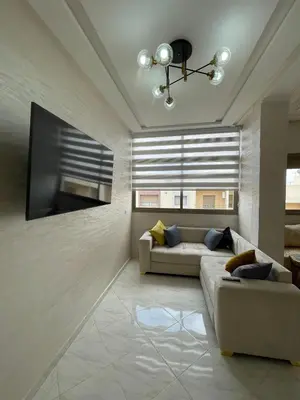 a living room with a couch and a large window at Housse Fez City in Fès