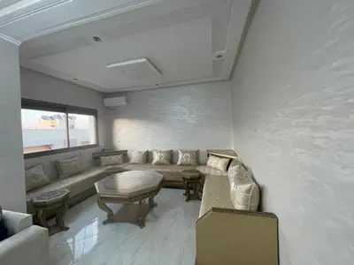 a living room with a couch and a table at Housse Fez City in Fès