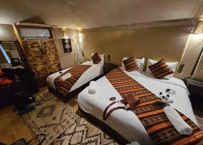 a hotel room with two beds in a room at Sahara Luxury Magic in Hassilabied