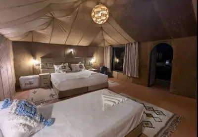 a large bedroom with two beds in a tent at Sahara Luxury Magic in Hassilabied