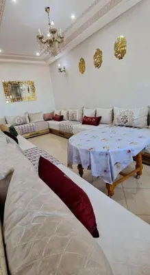 a living room with a couch and a table at Appartement Calme et Jolie près de l'aéroport in Oulad Tayeb
