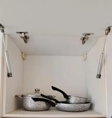two bowls are sitting on a shelf with lights at Appartement Calme et Jolie près de l'aéroport in Oulad Tayeb