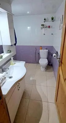 a bathroom with a white sink and a toilet at Appartement Calme et Jolie près de l'aéroport in Oulad Tayeb