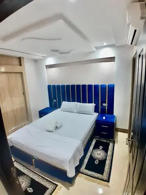 a bedroom with a large bed with a blue headboard at Meknes Luxe & Comfort in Meknès