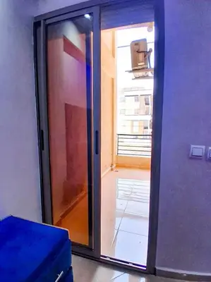 a glass door leading into a room with a window at Meknes Luxe & Comfort in Meknès