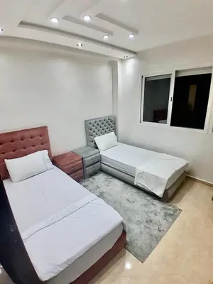 a room with two beds and a bench and two windows at Meknes Luxe & Comfort in Meknès