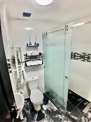 a bathroom with a toilet and a glass shower at Meknes Luxe & Comfort in Meknès
