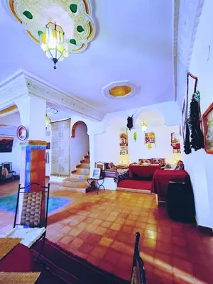 a living room with a couch and a table at Riad Kasbah des Roches in Akhendachou nʼAït Ouffi