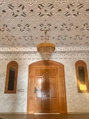a chandelier hanging over a door in a building at Riad El Menzeh in Meknès
