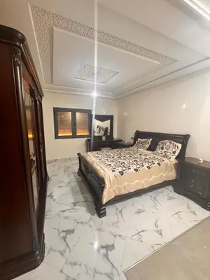 a bedroom with a bed and a marble floor at Riad El Menzeh in Meknès