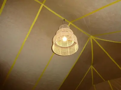 a light hanging from the ceiling of a room at lenas desert camp merzouga in Merzouga