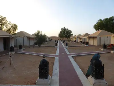 a village in the desert with tents in the background at lenas desert camp merzouga in Merzouga