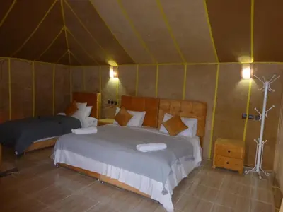 a bedroom with two beds in a tent at lenas desert camp merzouga in Merzouga