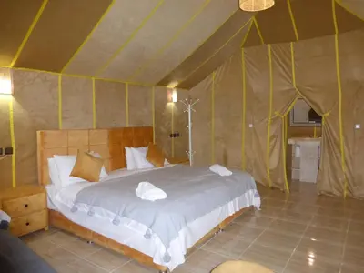 a bedroom with a bed in a tent at lenas desert camp merzouga in Merzouga