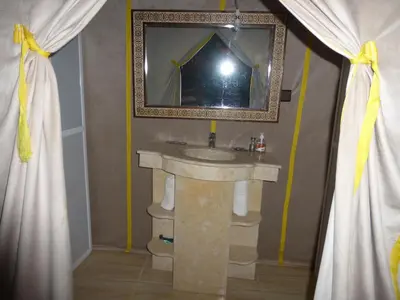a bathroom with a sink and a mirror at lenas desert camp merzouga in Merzouga