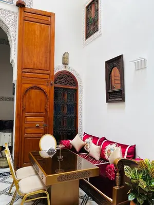 a living room with a couch and a table at Riad Fes Miracle in Fès al Bali