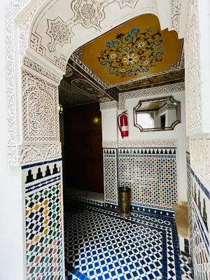 a room with a blue and white tiled floor with a ceiling at Riad Fes Miracle in Fès al Bali
