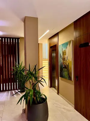 a hallway with a potted plant in a building at Hôtel Le Manoir in Taza