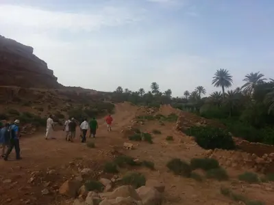 a group of people walking down a dirt road at Maison Ich chez Abdel in Ich