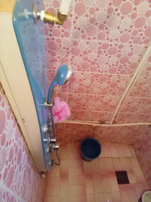 a bathroom with a toilet in a pink wall at Maison Ich chez Abdel in Ich