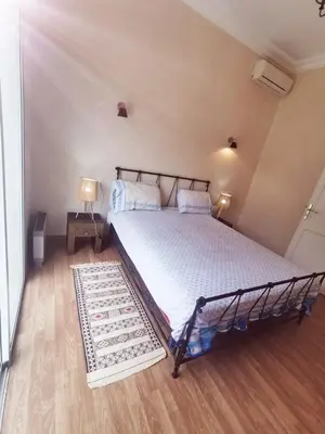 a bedroom with a large bed with a rug at Paradise Berber in Akkara