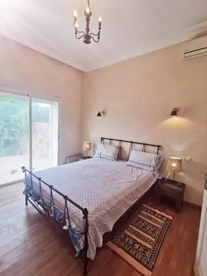 a bedroom with a bed and a large window at Paradise Berber in Akkara