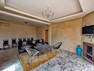 a living room with a couch and a fireplace at Paradise Berber in Akkara