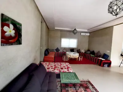 a living room with a couch and a table at Paradise Berber in Akkara