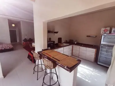 a kitchen with a table and some chairs in a room at Paradise Berber in Akkara