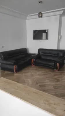two black blankets sitting on the floor in a room at Les Appartements de la Place Atlas in Fès