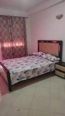 a bedroom with a bed in a room at Les Appartements de la Place Atlas in Fès