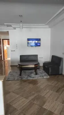 a living room with a couch and a coffee table at Les Appartements de la Place Atlas in Fès