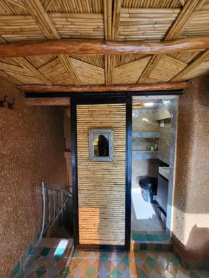 a room with a staircase and a door with a window at Duplex Reposant avec piscine au Andalines Golf Royal Fès in Dar Ito Lahssene