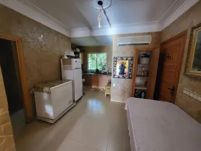 a kitchen with a refrigerator and a sink in it at Duplex Reposant avec piscine au Andalines Golf Royal Fès in Dar Ito Lahssene