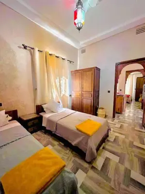 a bedroom with two beds in a room at Villa des tortues 3 Marrakech piscine chaufée privative sans vis à vis in Marrakech