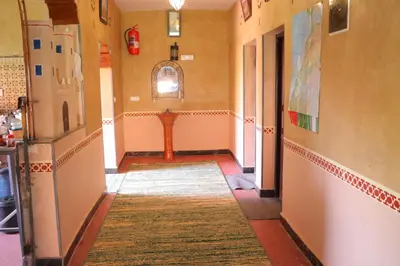 a hallway with a rug on the floor of a room at Gite d'étape Tafsoute in Tameskikt