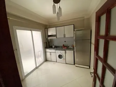 a kitchen with a refrigerator and a dishwasher at apartement moderne fes in Fès