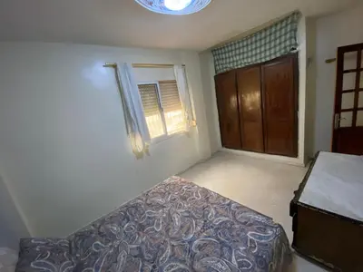 a bedroom with a bed and a window at apartement moderne fes in Fès