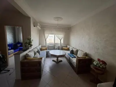 a living room with a couch and a table at Appartement à côté de Kitea route de Sefrou in Fès