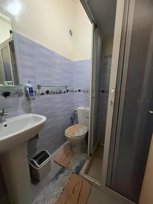 a bathroom with a toilet and a sink and a shower at Appartement à côté de Kitea route de Sefrou in Fès