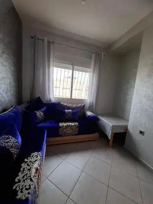 a living room with a couch and a window at Appartement à côté de Kitea route de Sefrou in Fès