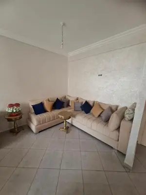 a living room with two couches and a table at Appartement à côté de Kitea route de Sefrou in Fès